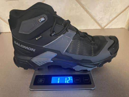 Close up of Salomon X Ultra 5 hiking boot on a kitchen scale that reads 1 lb 1 oz