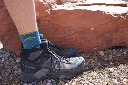 X Ultra 5 Mid GTX hiking boots in front of a red rock boulder